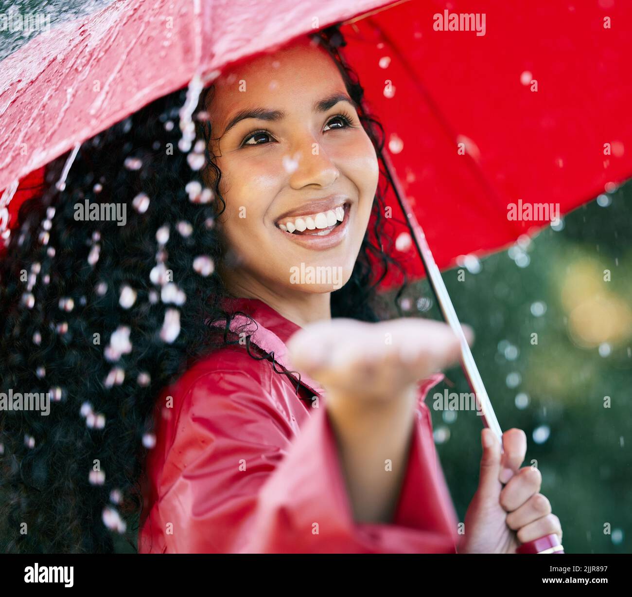 Surrounded by showers of blessings. a beautiful young woman standing in