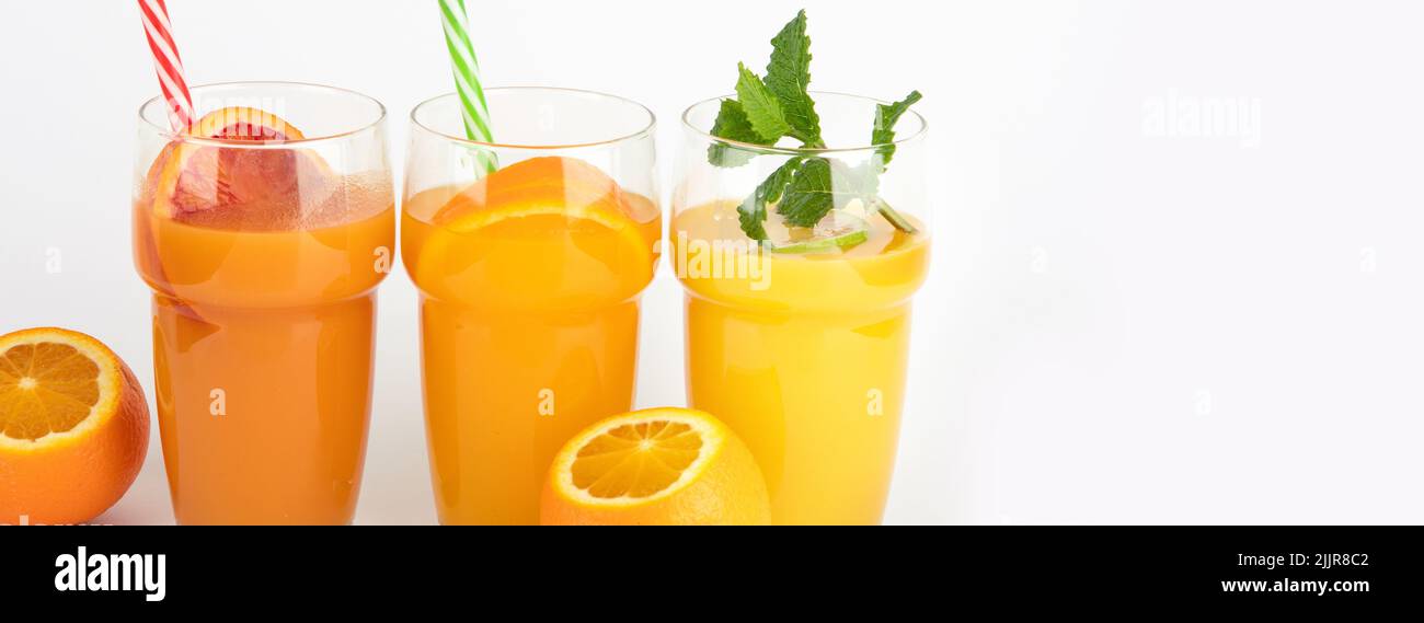 Fruit juices assortment on light background. Freshly made drinks. panorama Stock Photo