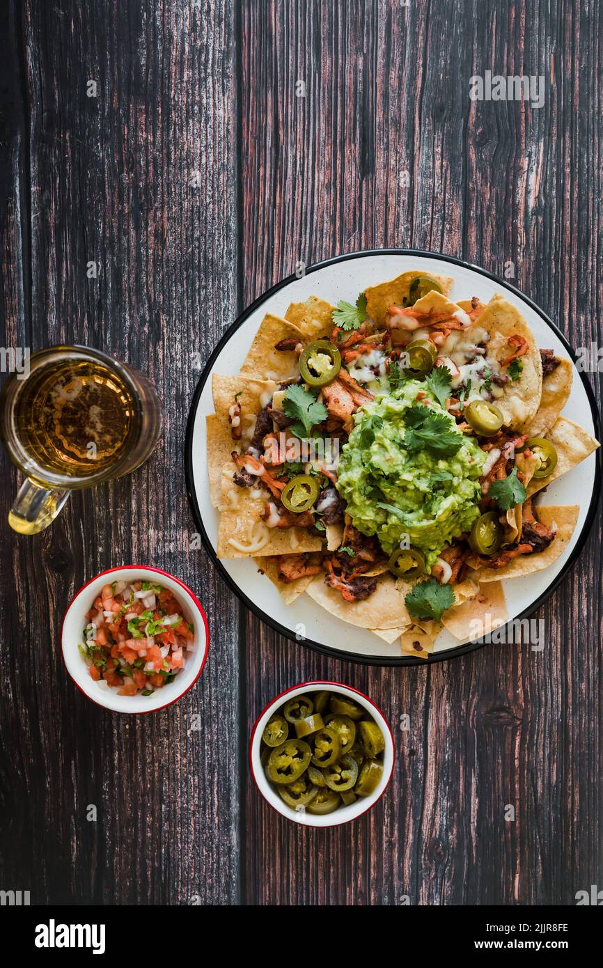 Mexican nachos chips with american cheese and avocado, traditional food in Mexico Latin America