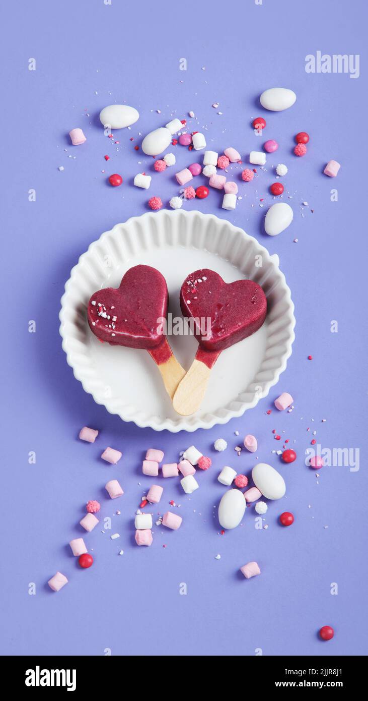 Violet blueberry ice-cream on lilac background. Atmospheric sweet menu concept. Top view, flat lay, copy space Stock Photo