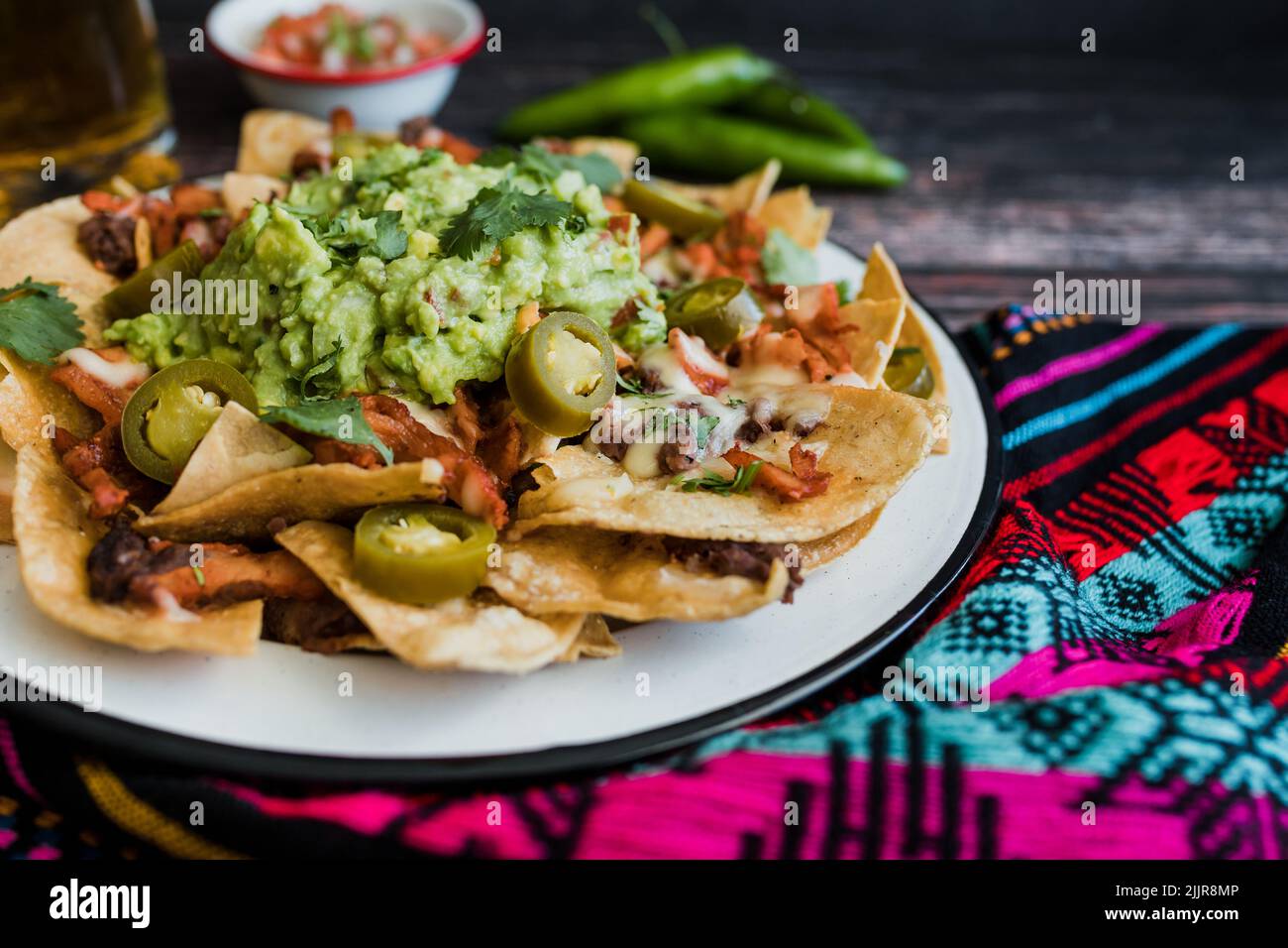 Mexican nachos chips with american cheese and avocado, traditional food in Mexico Latin America Stock Photo