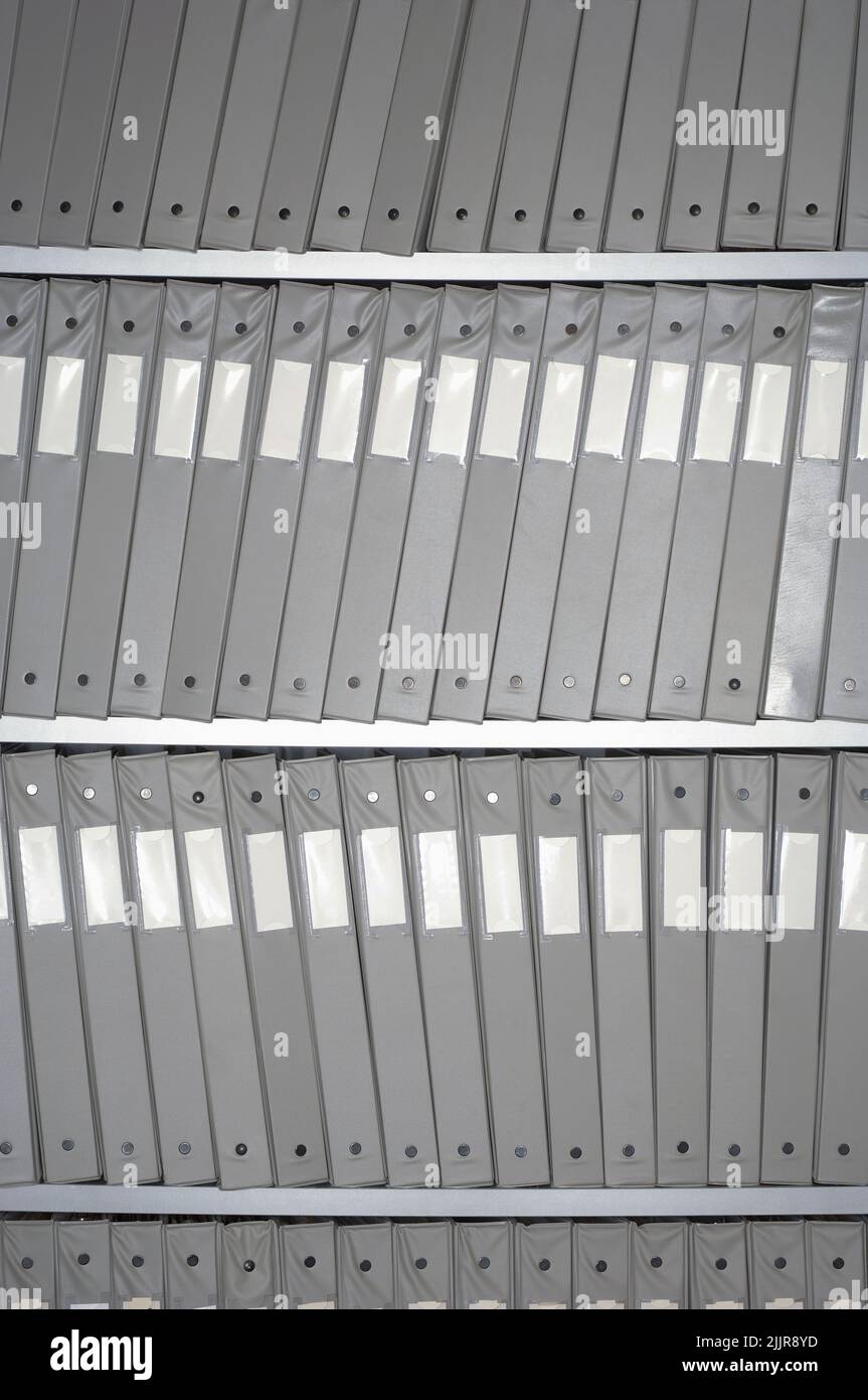 A vertical grayscale shot of archival storage of documents Stock Photo
