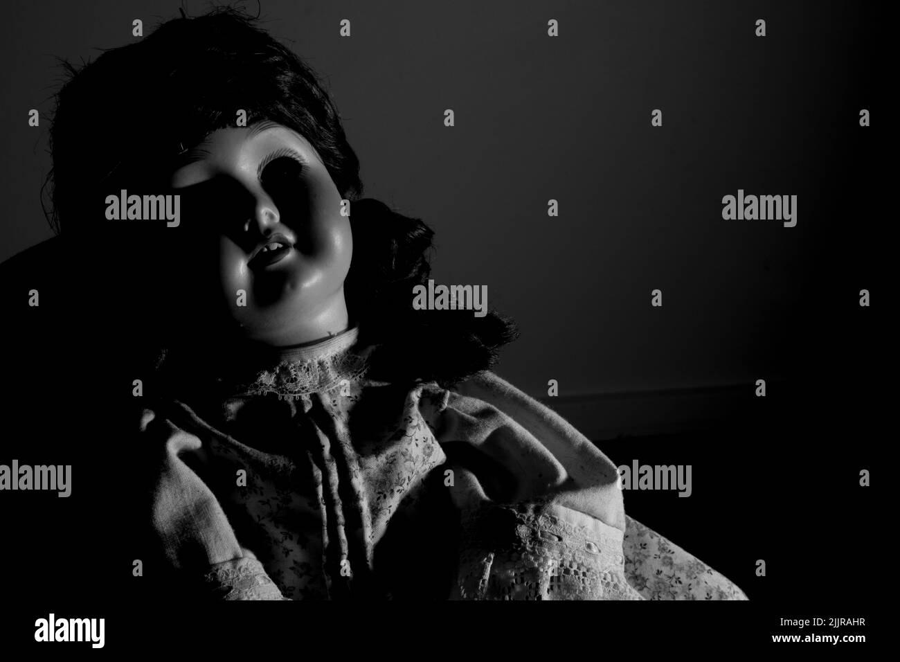 Creepy porcelain doll in monochrome Stock Photo