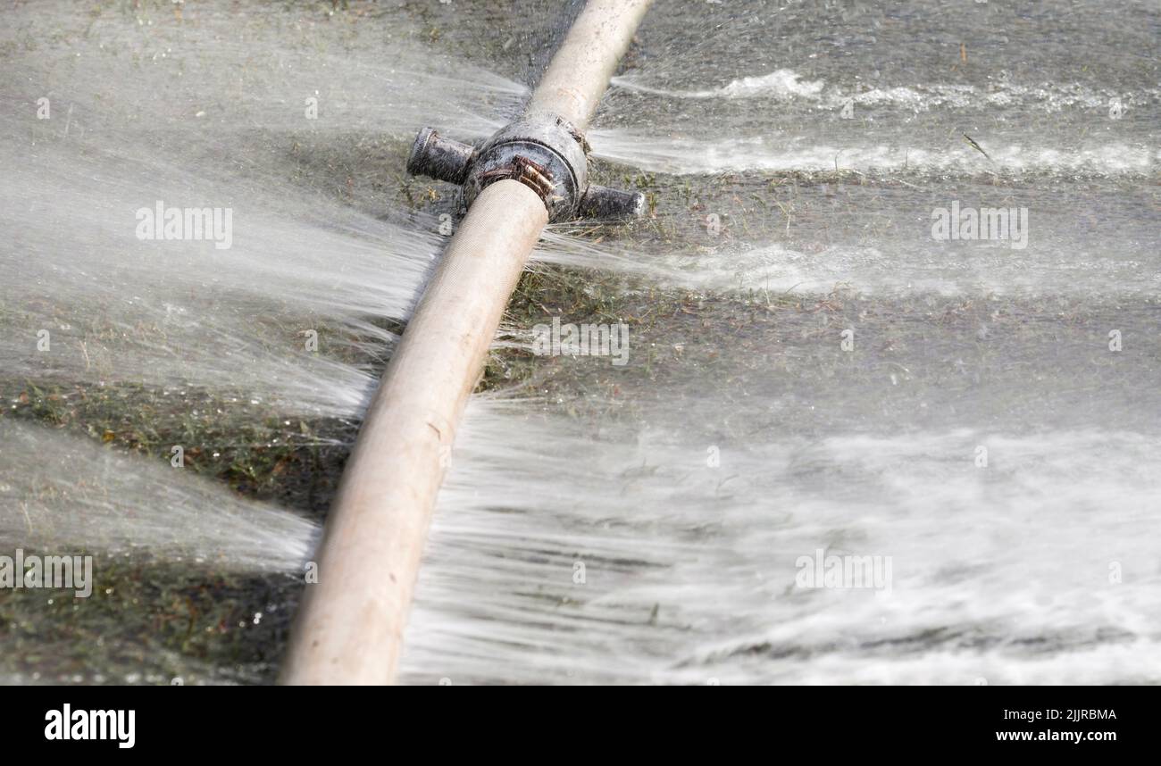 water leaking from hole in a hose Stock Photo Alamy