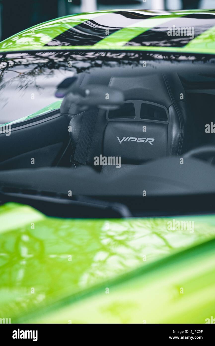 A vertical shot of car interior ,outside view of green Dodge Viper SRT 10 through window Stock Photo