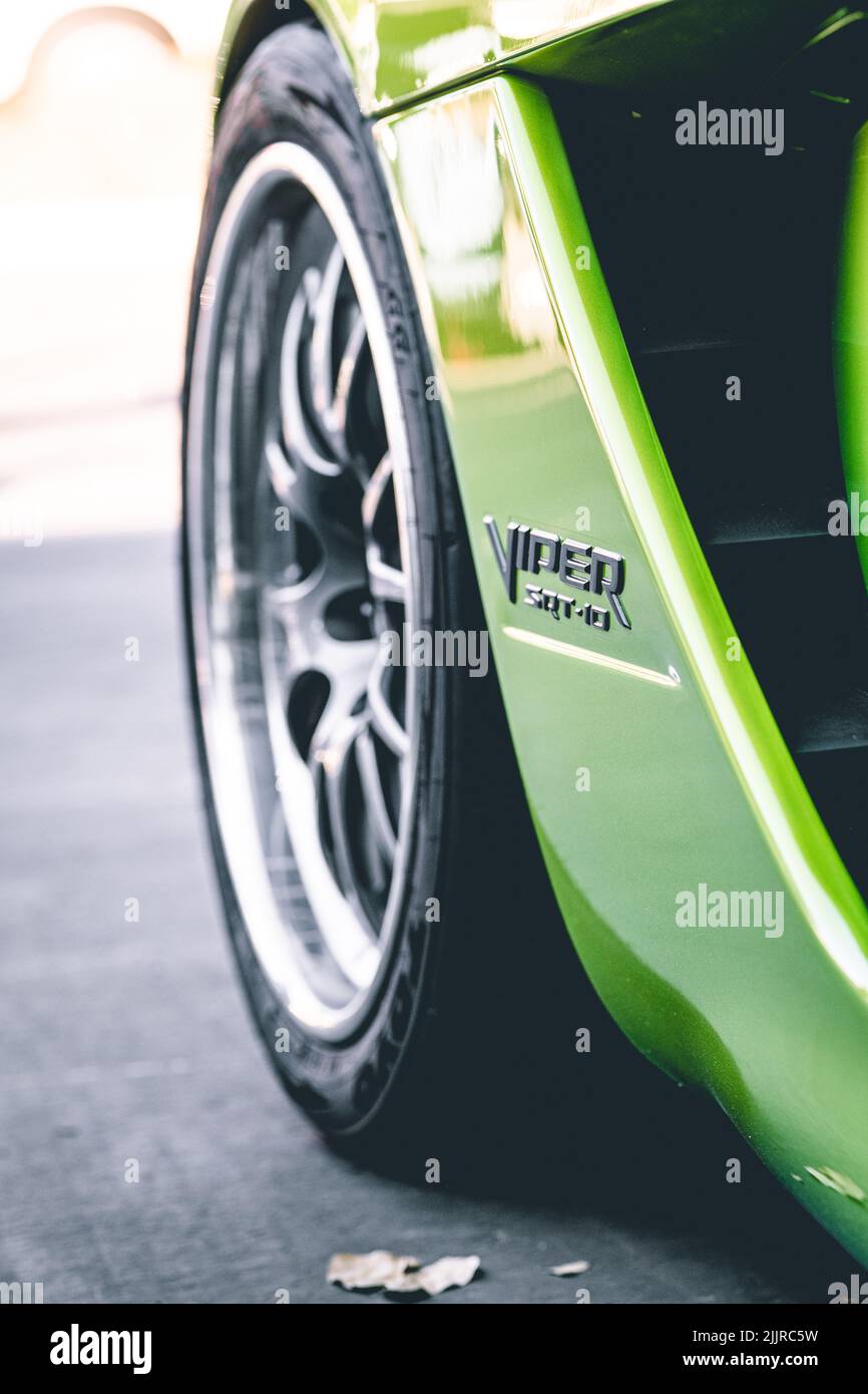 A vertical close-up of a green Dodge Viper SRT 10 car wheel Stock Photo
