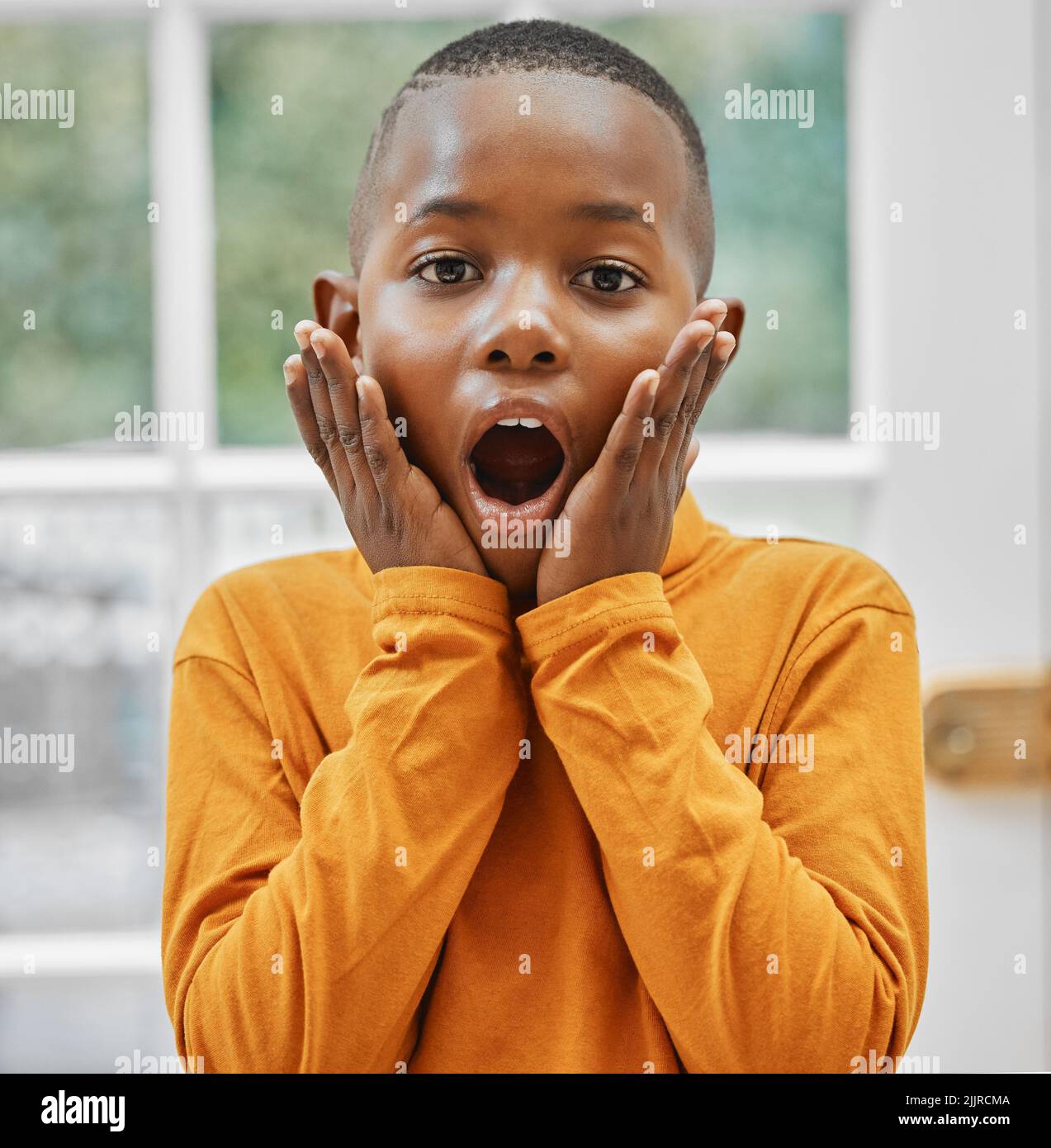 Thats shocking. a little boy looking shocked at home. Stock Photo