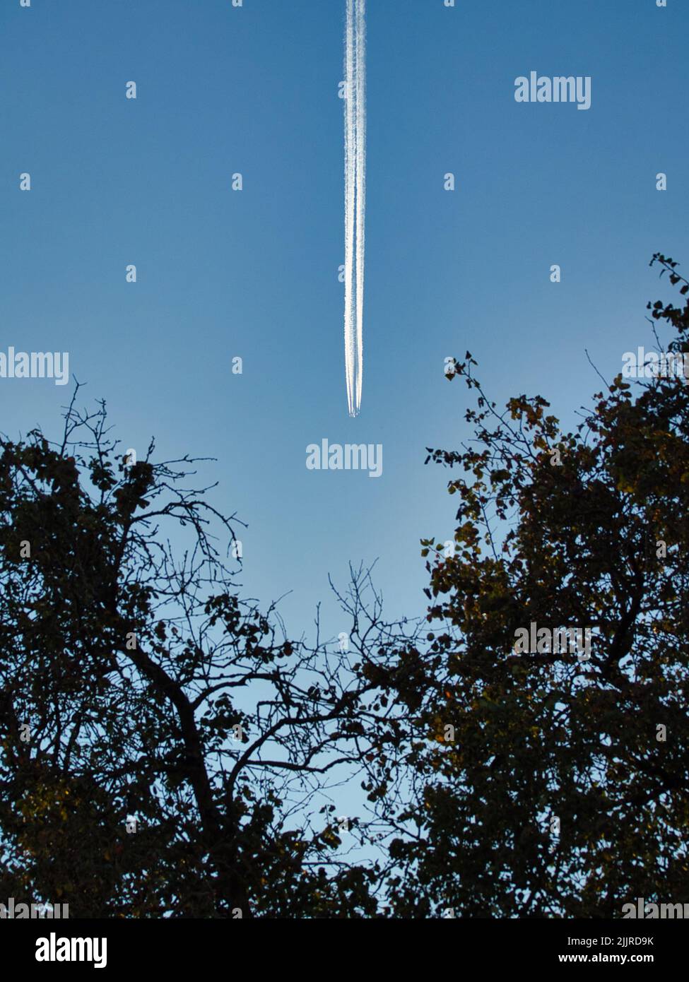 A bottom view of a beautiful blue sky with traces of plane Stock Photo