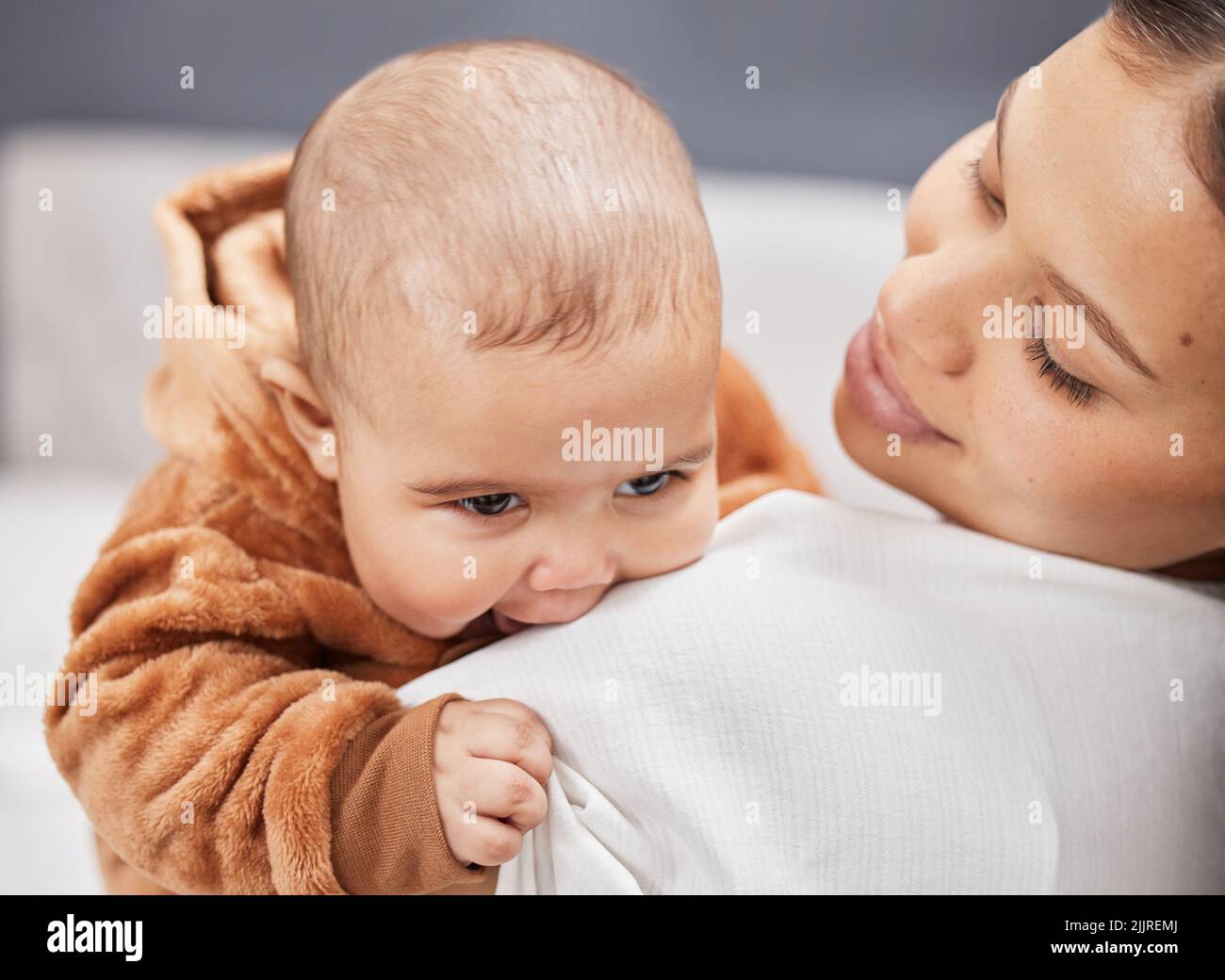 Oh no are you teething. a young mother holding her baby boy. Stock Photo