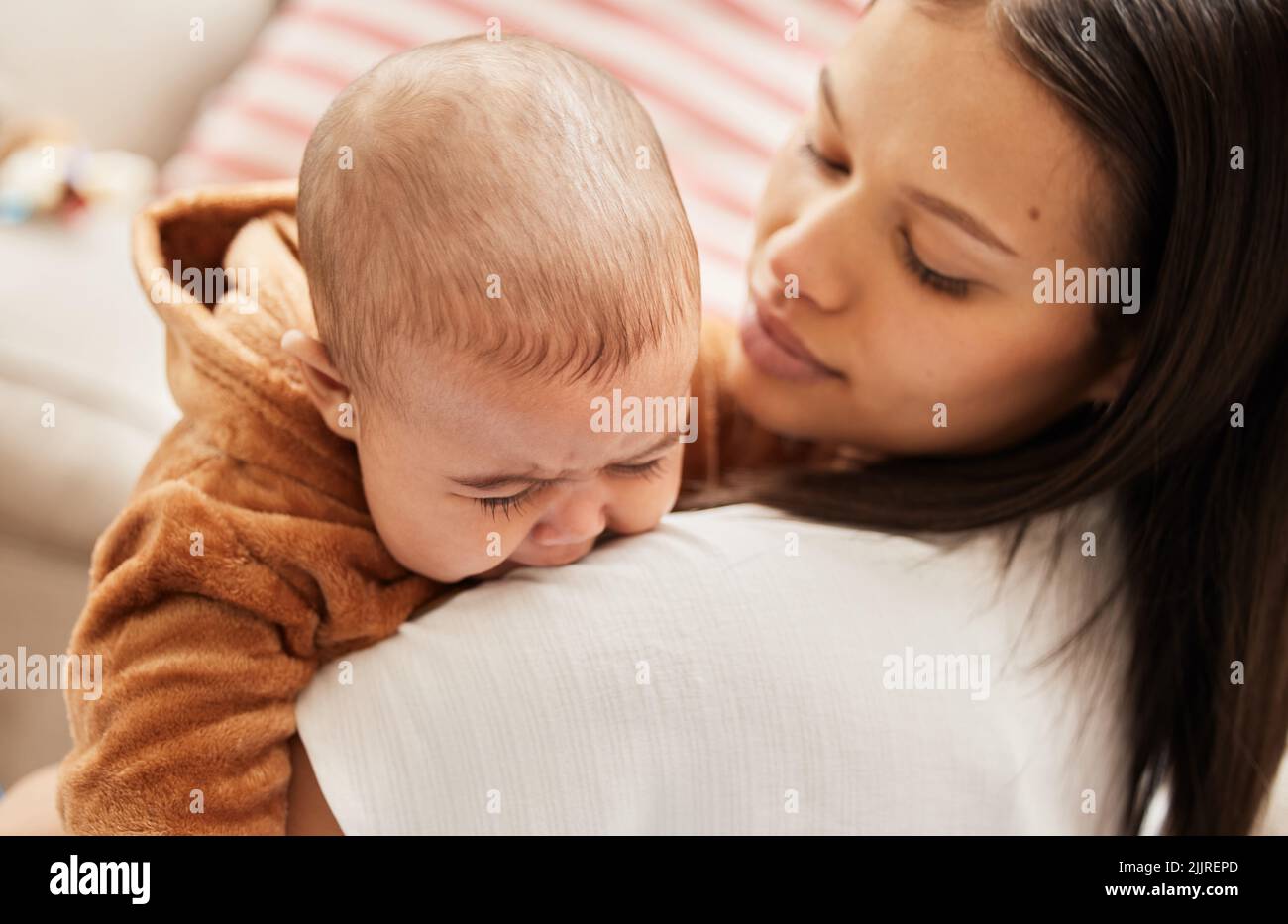 What happened my little one. a young mother consoling her crying baby. Stock Photo