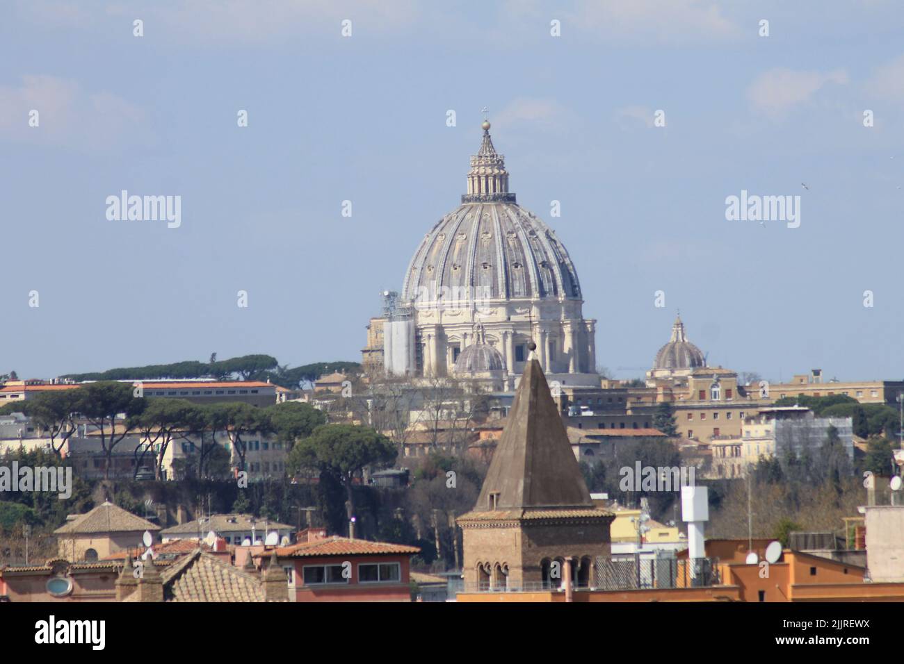 A distant view of the Saint Peter's Basilica with buildings in the ...