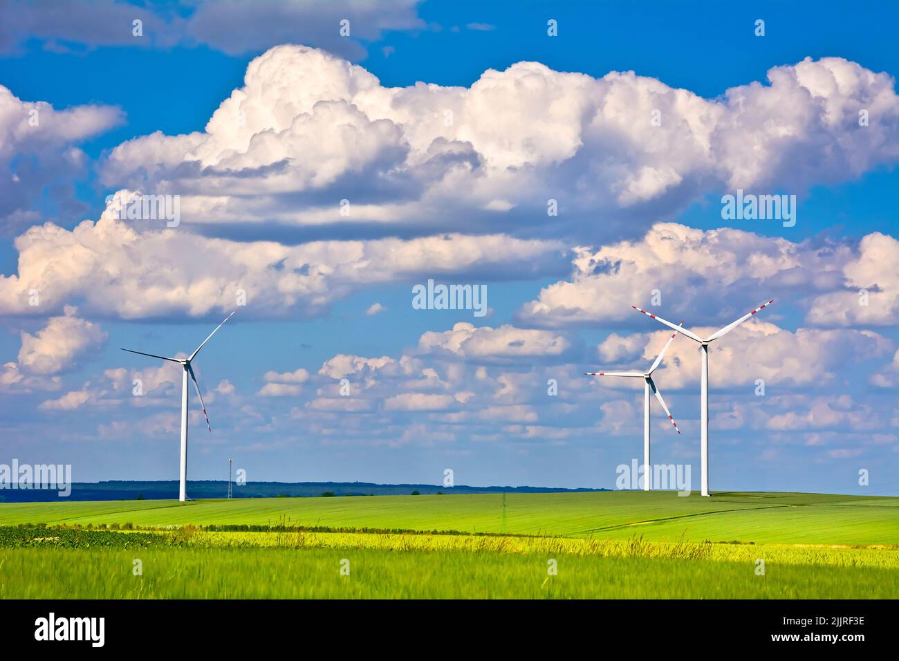 A wind turbines and green field on sunny day Stock Photo - Alamy