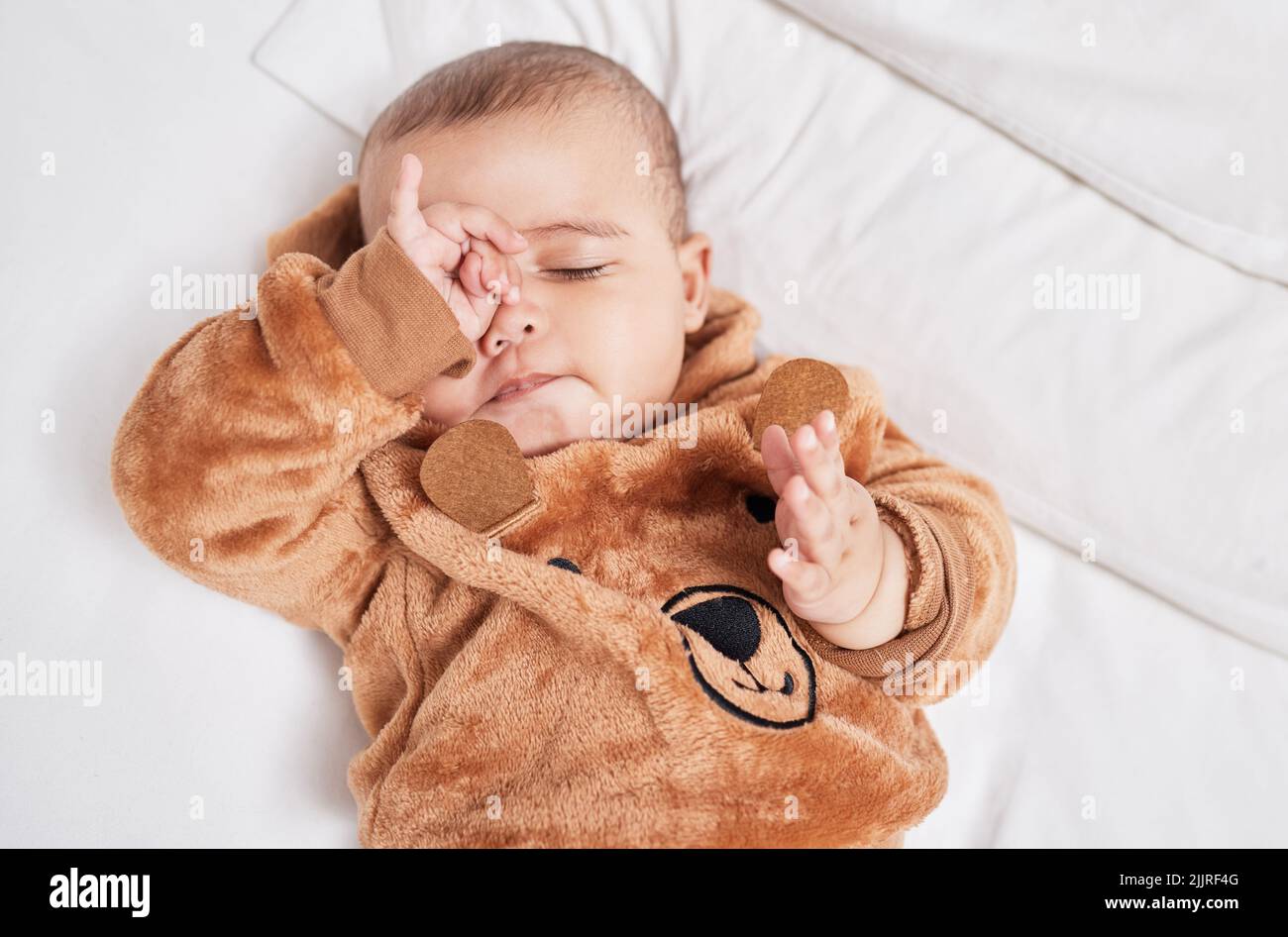 Sleep is for the weak. a baby boy rubbing his eyes in exhaustion Stock