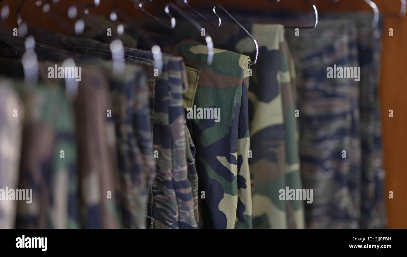 Collection of military uniform trousers in wardrobe Stock Photo Alamy