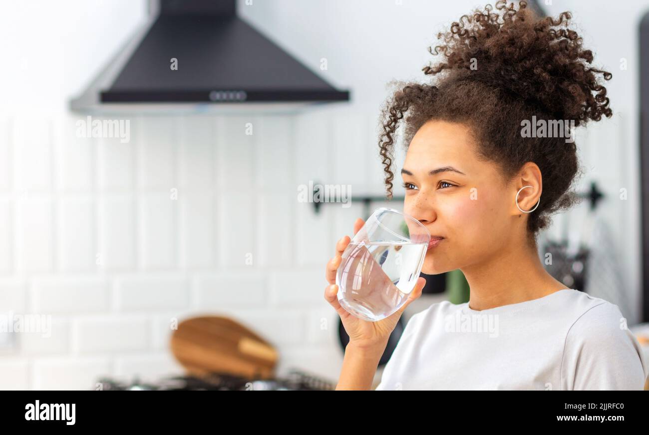 Healthy lifestyle concept. Beautiful young woman drinking clean water  Stock Photo