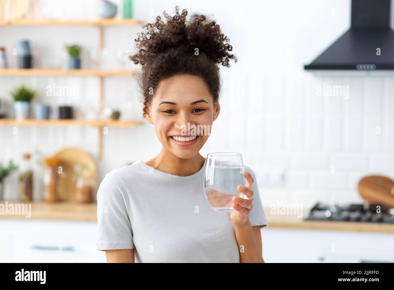 Healthy lifestyle concept Beautiful young woman holding glass of clean fresh water Stock Photo