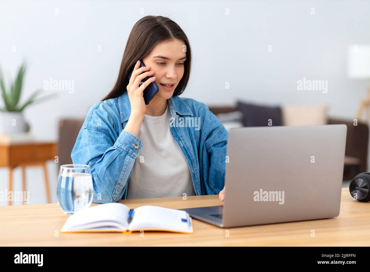 woman freelancer or office employee working remotely using laptop Stock Photo