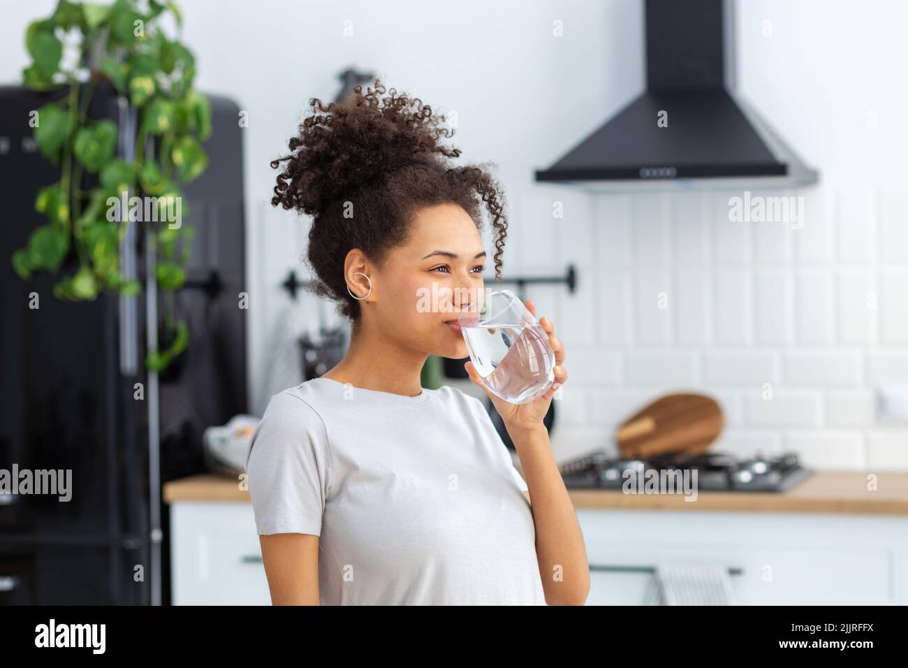 Healthy lifestyle concept. Beautiful woman drinking clean water Stock Photo