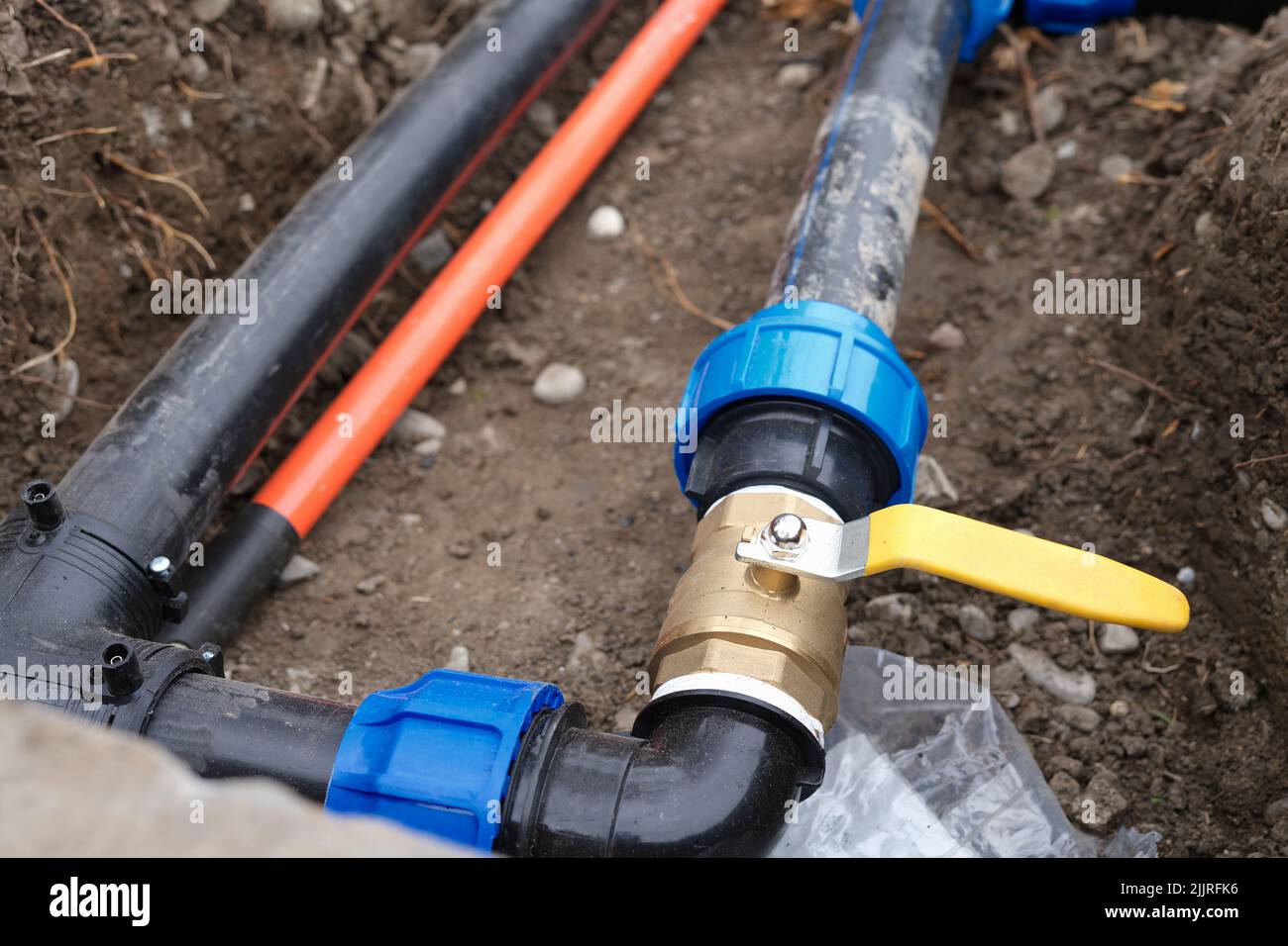 Underground irrigation system with elbow fitting of pvc pipes at bend