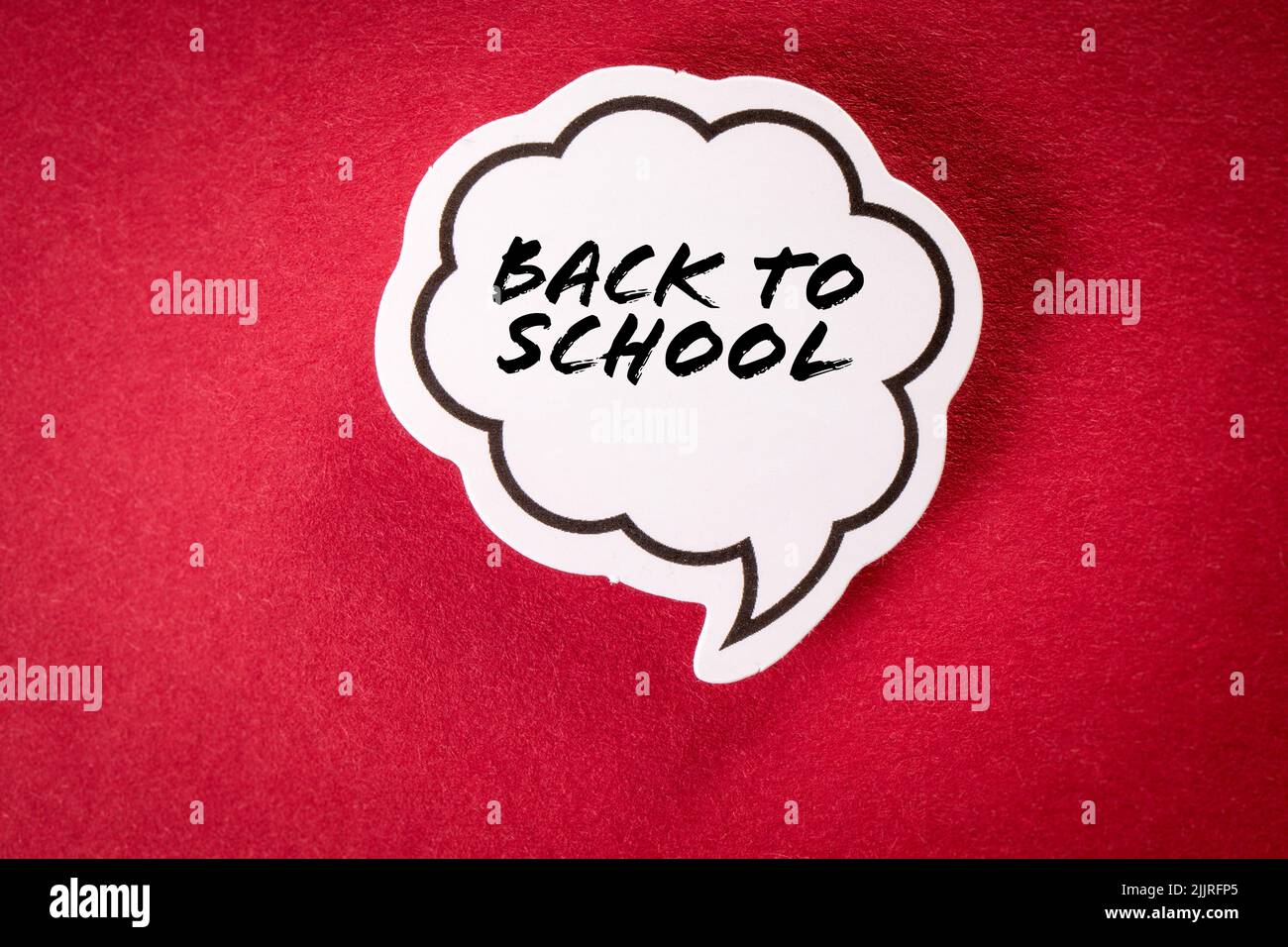 Back to school. Speech bubble with text on red background. Stock Photo