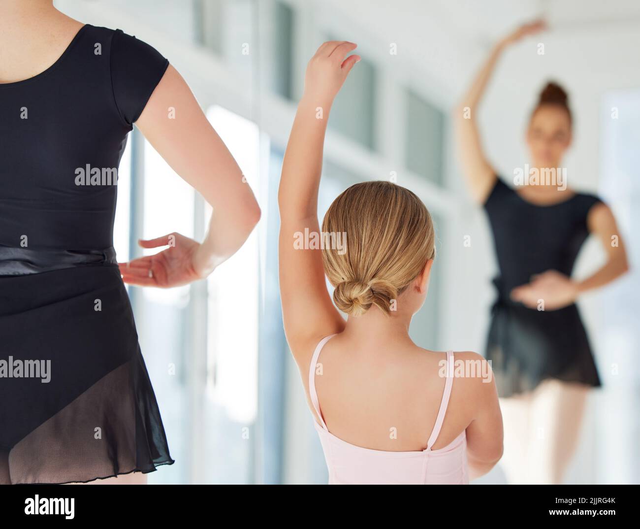 Ballet something pure in this crazy world. a little girl practicing ballet with her teacher in a dance studio. Stock Photo