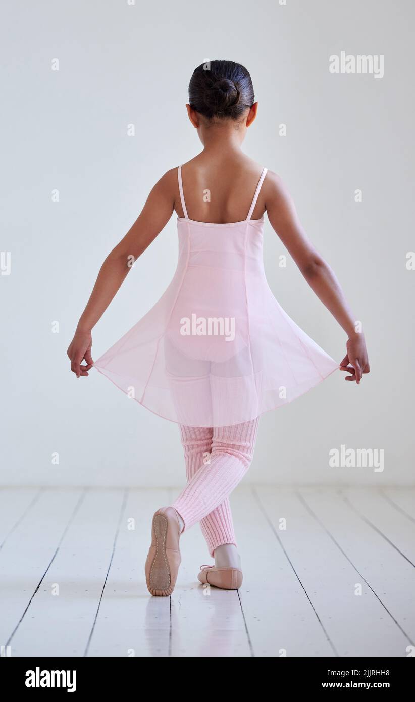 Shes an aspiring ballet dancer. Rearview shot of a little girl ...