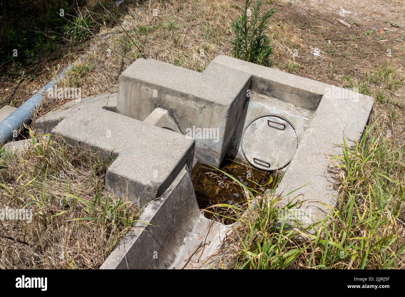 Agriculture water irrigation canals system with manholes to control the flow and direction of water Stock Photo