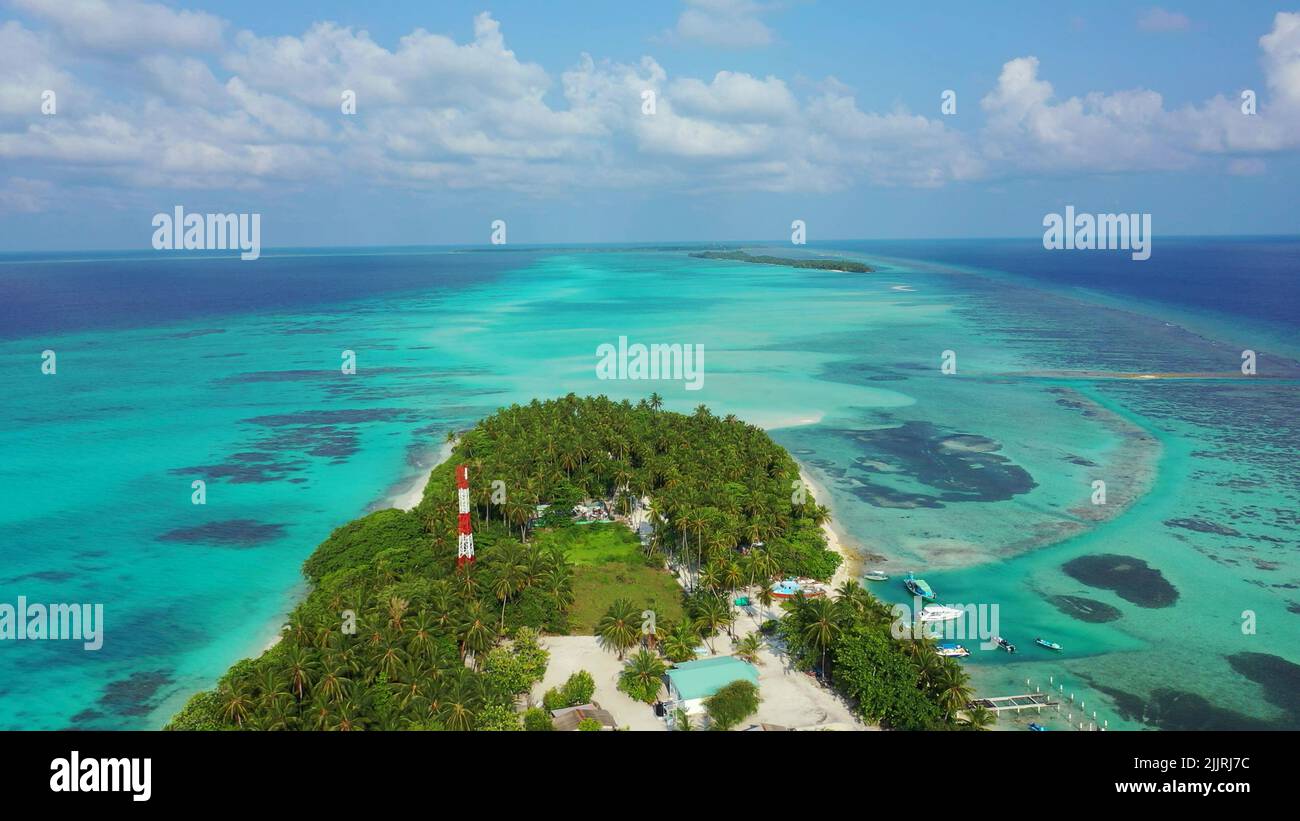 An aerial view of lush green tropical island in the middle of the ocean ...