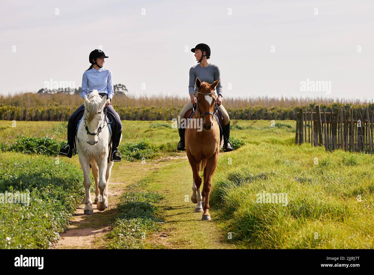 Lets got for a ride. Full length shot of two young woman riding their ...