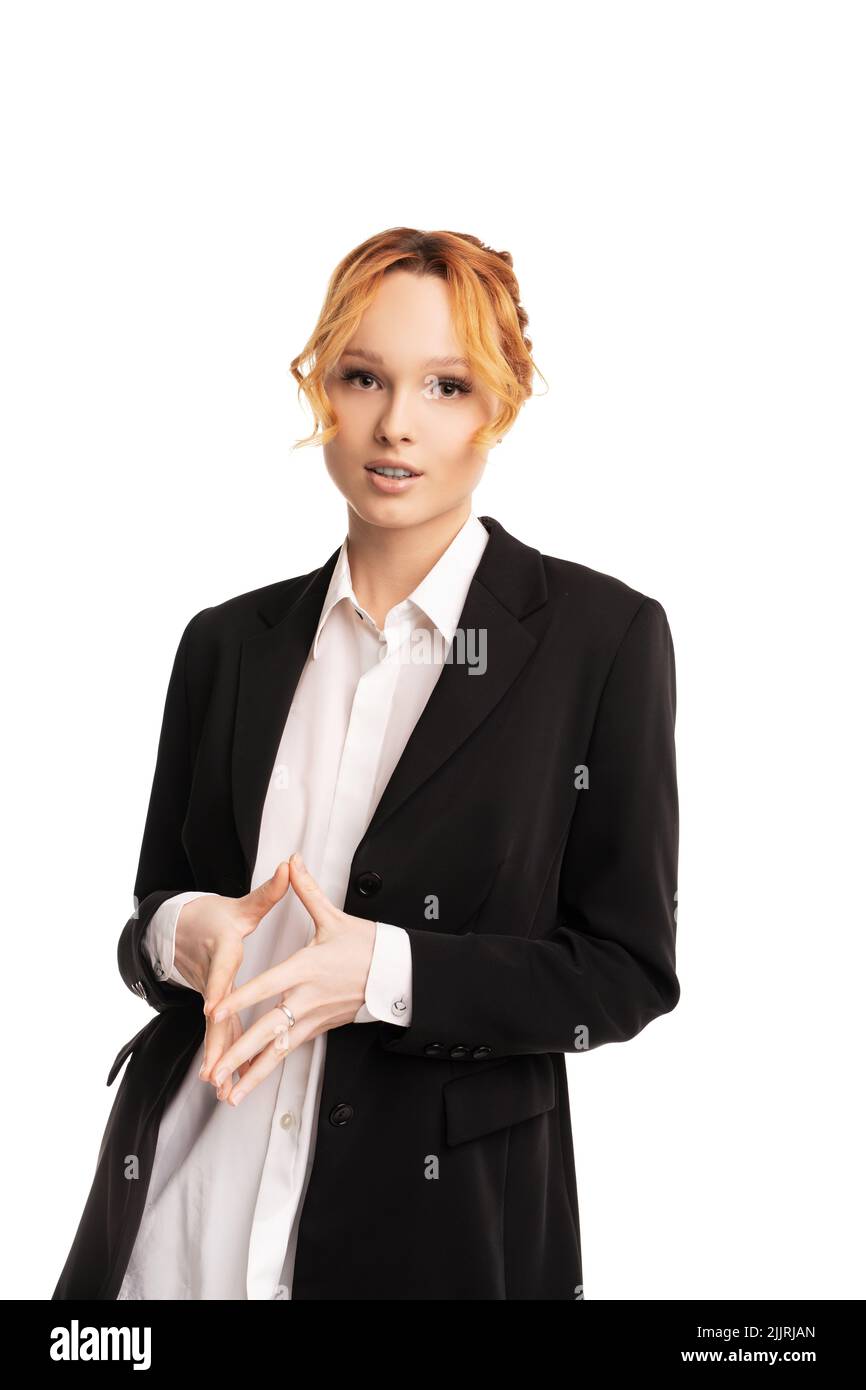 Young businesswoman standing in white studio and looking at camera Stock Photo