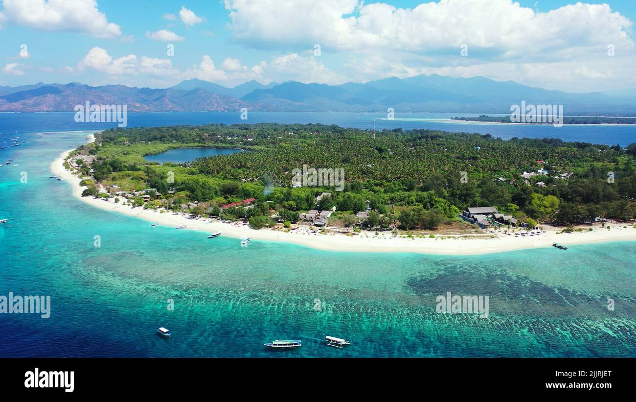 Thicken Intrusion Behov for A drone footage of a Island with a cloudy sky and mountains on the  background in Asia Stock Photo - Alamy