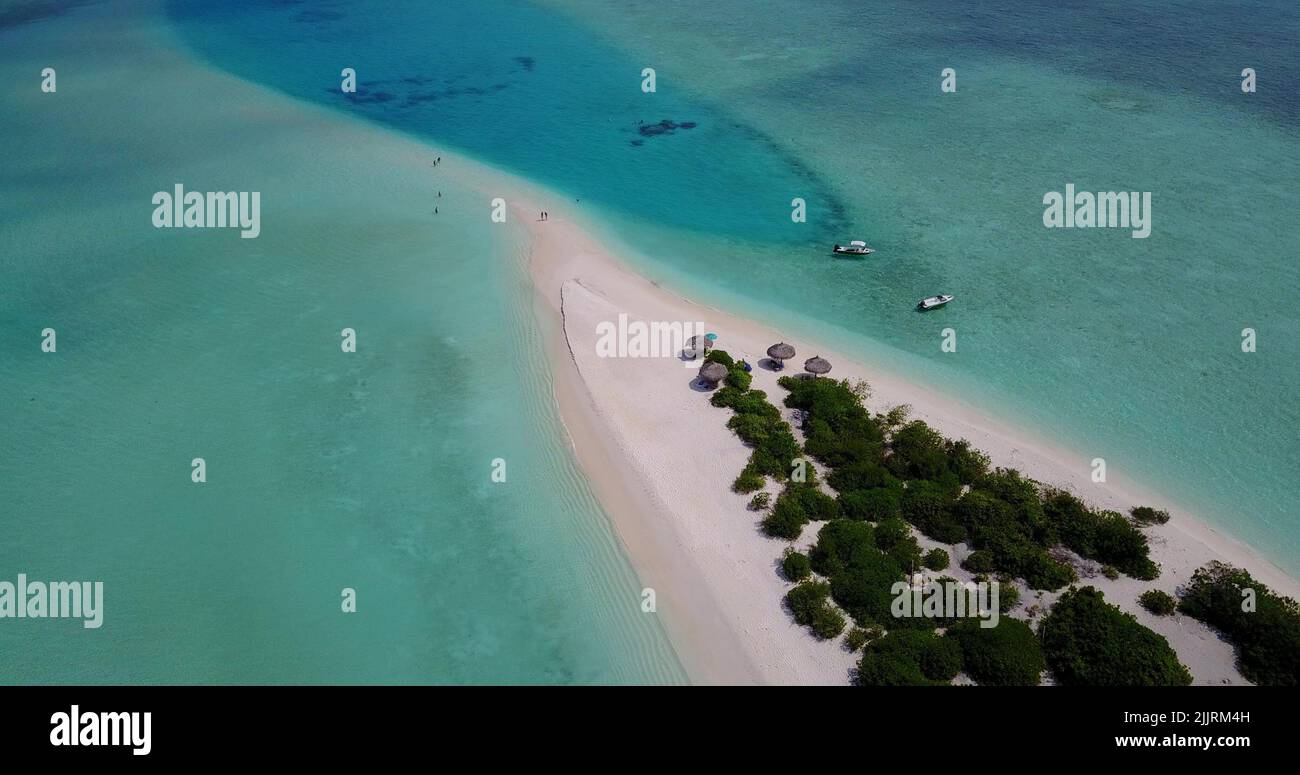 An Aerial view of a small tropical island with a white sandy beach and ...
