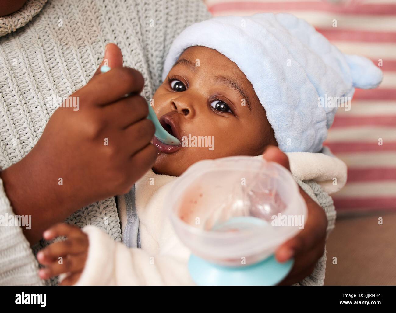 Tastes like more. an adorable baby girl being fed by her mother at home. Stock Photo