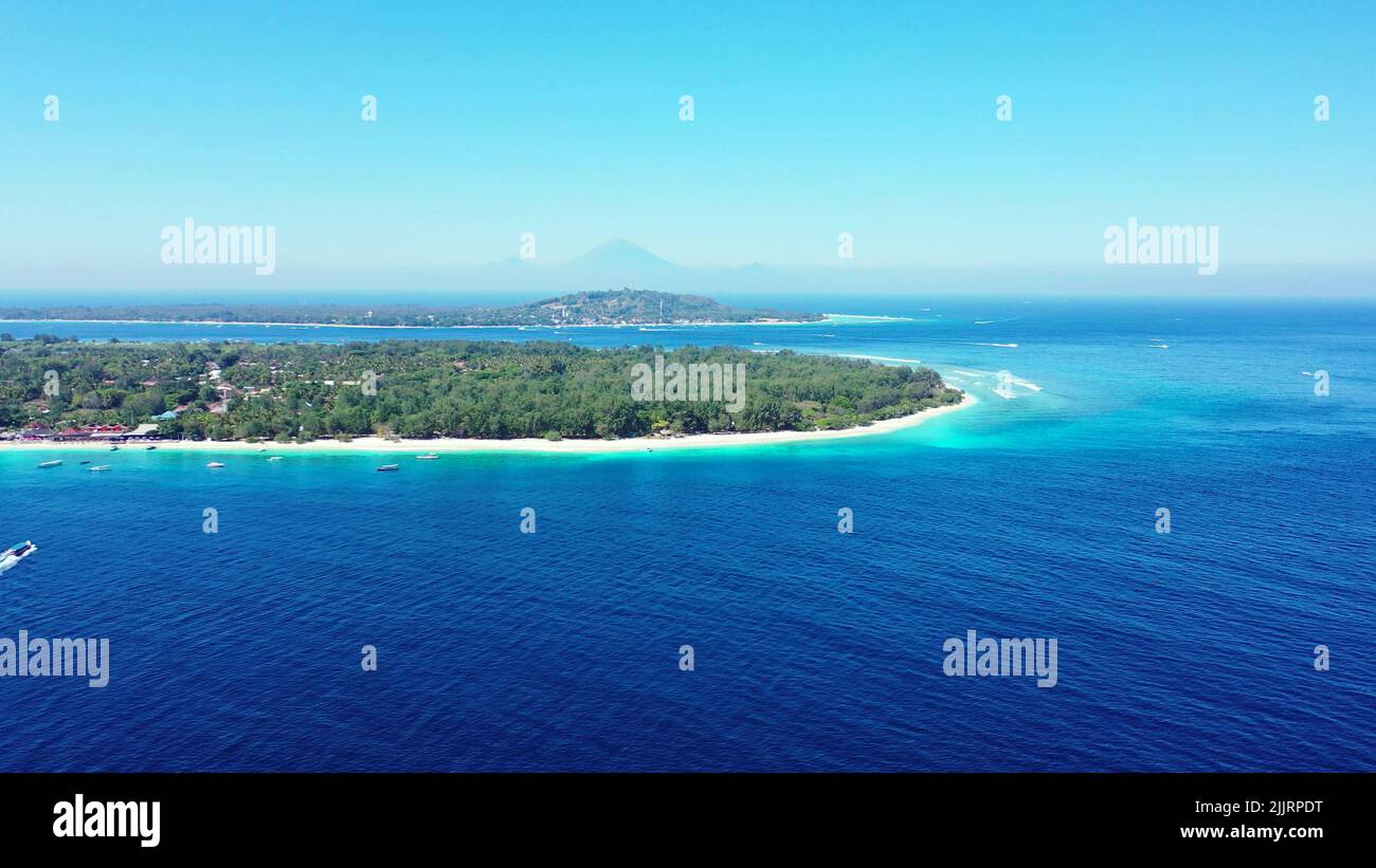 A mesmerizing view of a small green island in blue sea of The Maldives ...