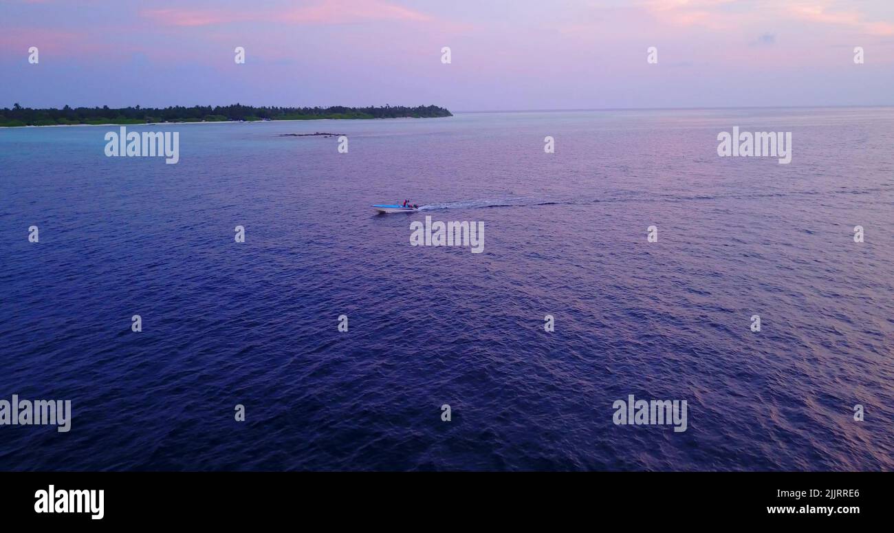 An aerial view of a yacht in the ocean during sunset Stock Photo - Alamy