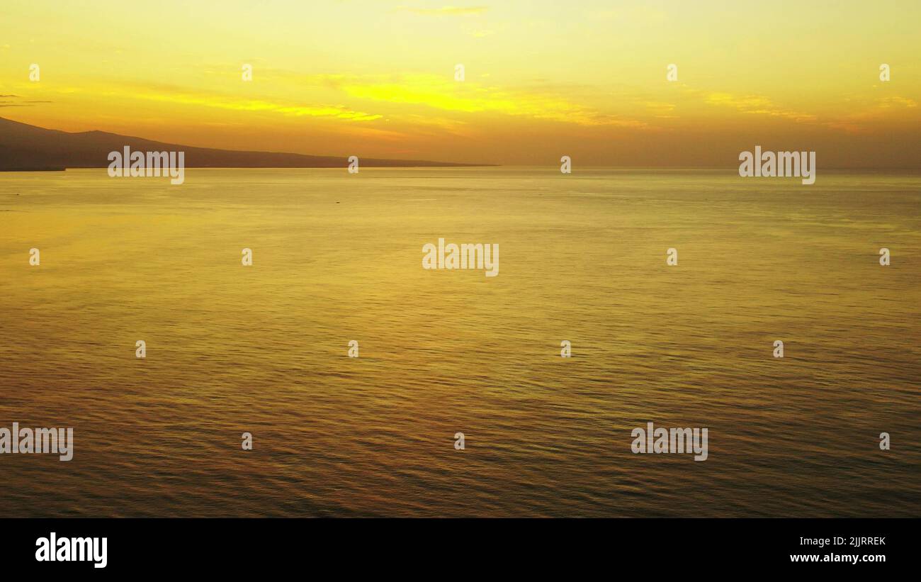 The breathtaking yellow clouds during sunrise over the ocean Stock ...