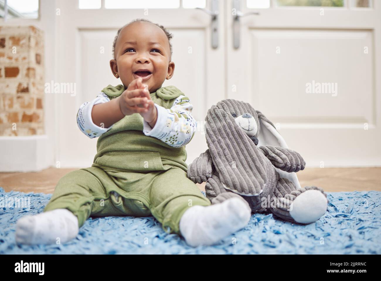 Clap hands Yeah I can do that. an adorable baby girl at home Stock