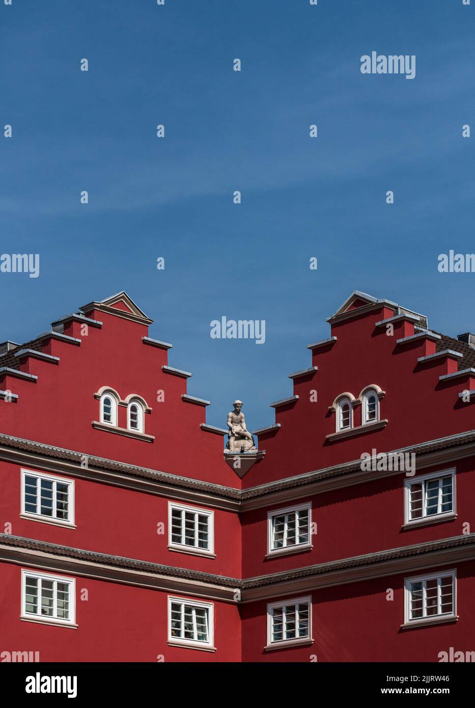 A vertical shot of two red buildings with sharp roofs in Aachen, Juelicher Strasse, Germany Stock Photo