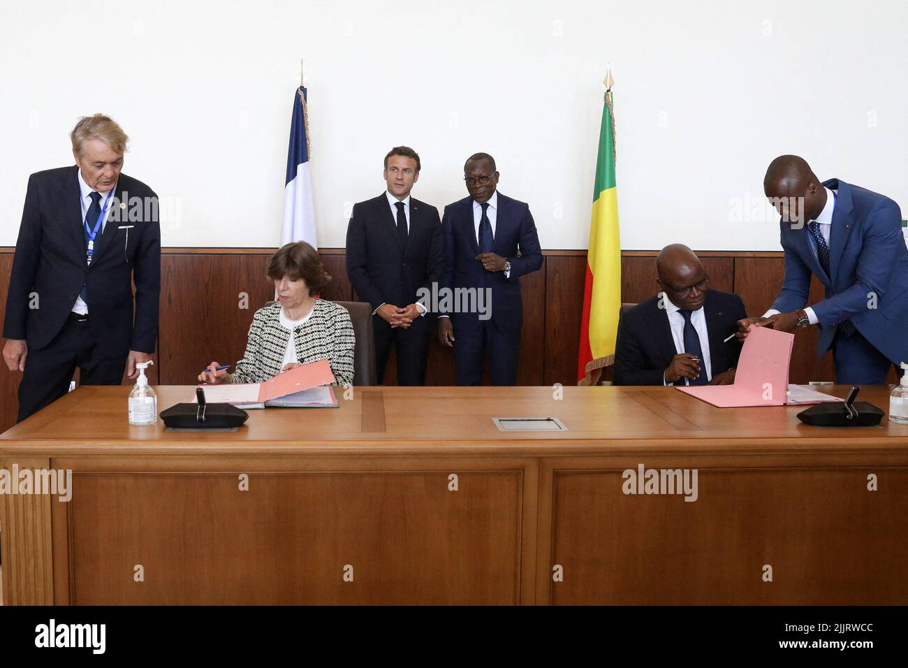 French Foreign and European Affairs Minister Catherine Colonna and her  Beninese counterpart Aurelien Agbenonci signing an agreement as France's  President Emmanuel Macron and Benin's President Patrice Talon look on, at  the Marina