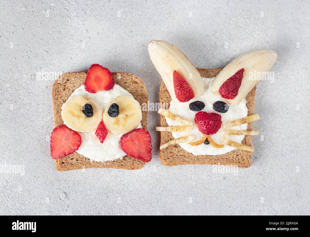 Two sweet toasts for kids in shape of chick and rabbit with ...