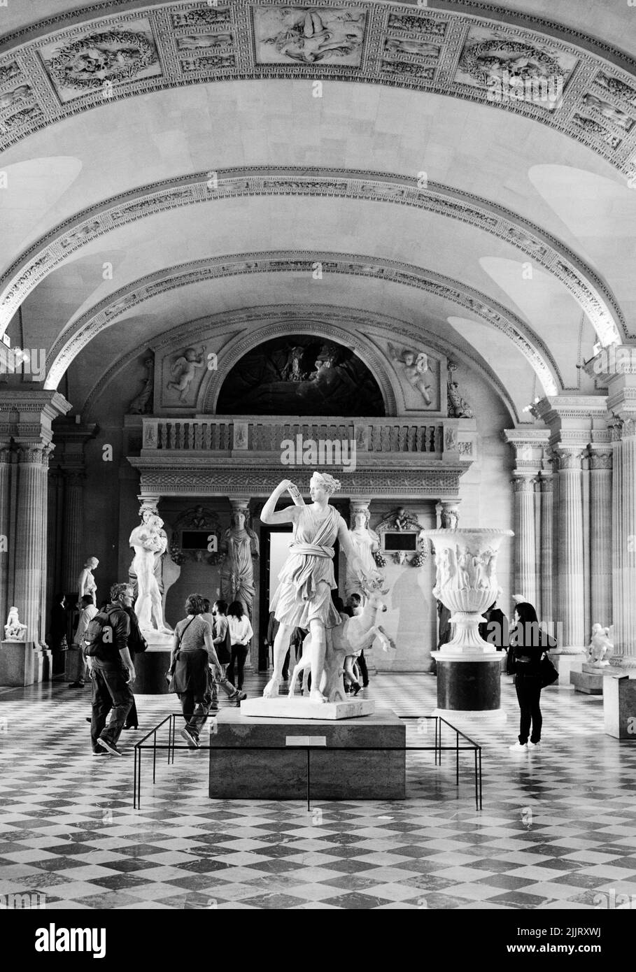 A vertical of sculptures in the Louvre museum in Paris, France shot in grayscale Stock Photo