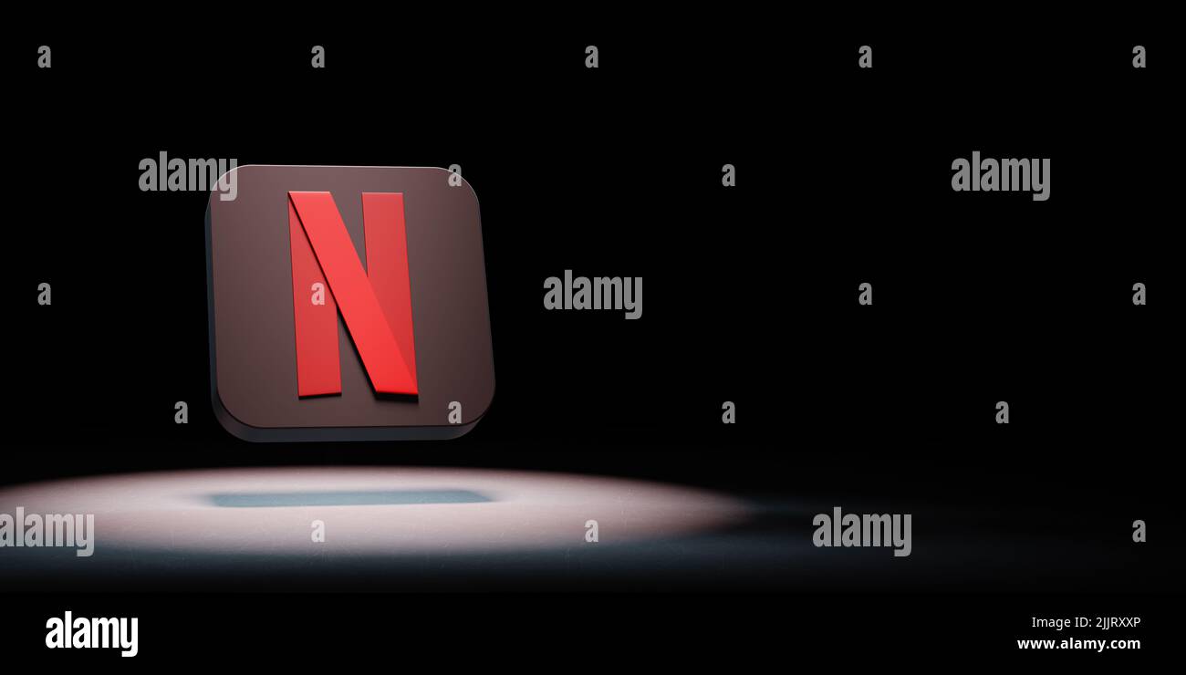 Netflix Logo Spotlighted on Black Background Stock Photo