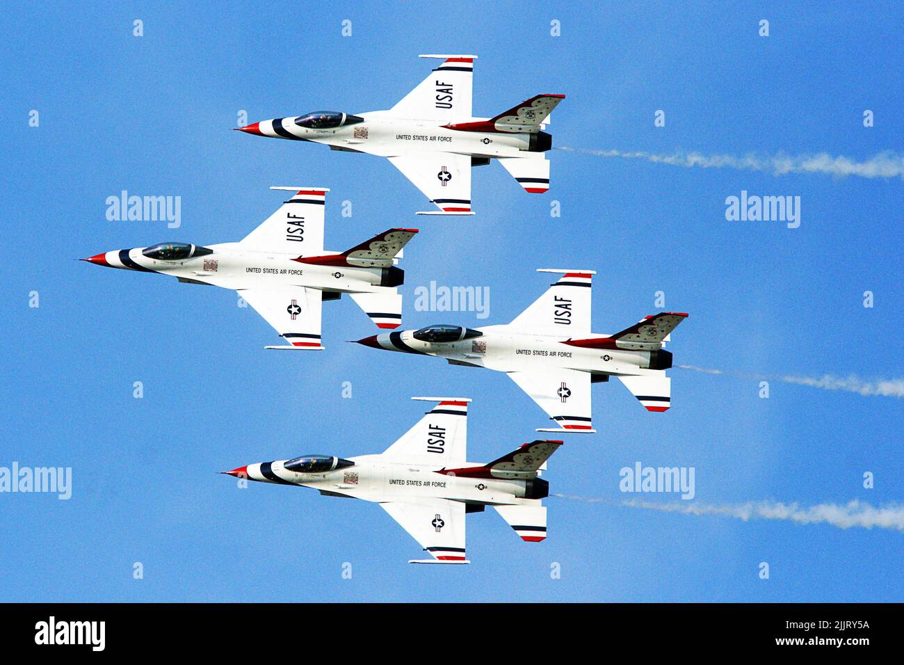 A closeup of USAF Thunderbirds air force flying in a blue sky Stock Photo