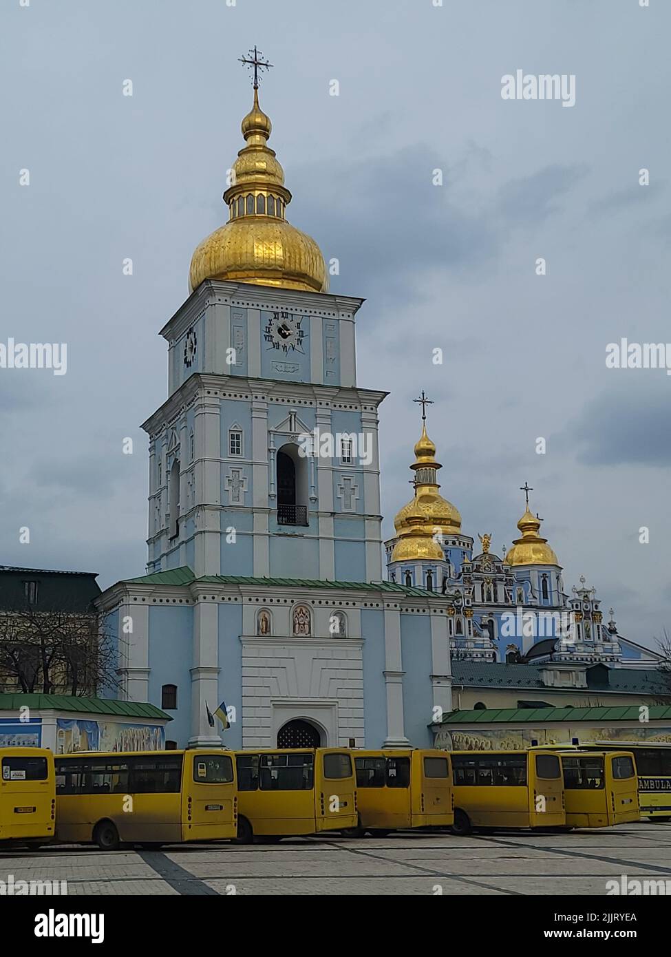 A vertical shot of ambulance buses in front of St. Michael's Golden-Domed Monastery in Kyiv, Ukraine. Stock Photo