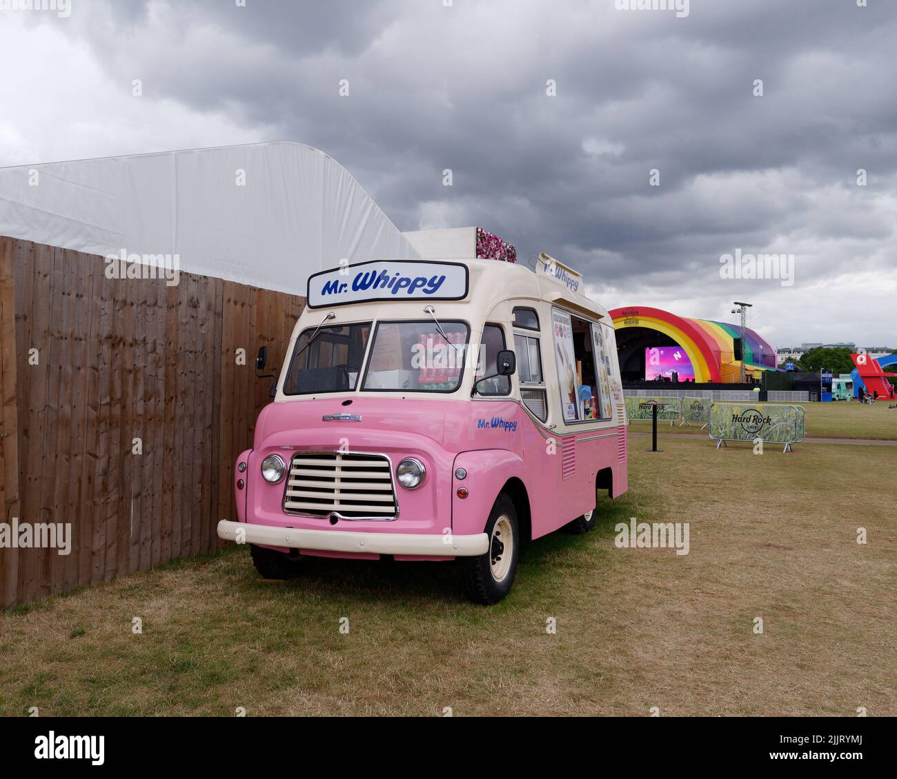 London, Greater London, England, June 30 2022: Pink and white ice cream van with a music stage behind in BST Hyde Park Stock Photo