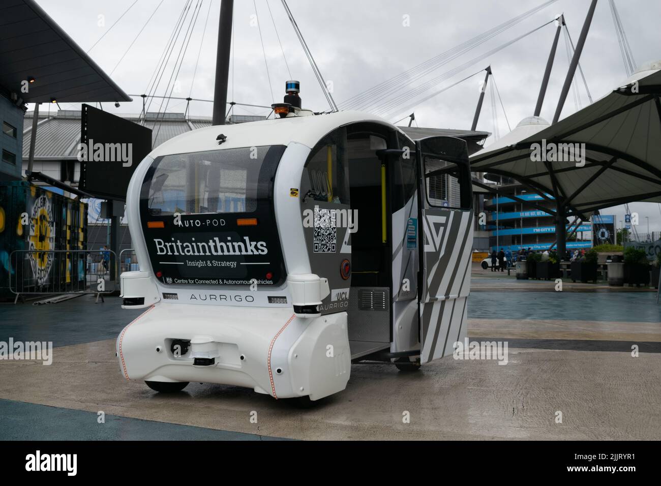 tihad Campus. Driverless white car in rain with text Centre for Connected and Autonomous Vehicles. Sensor shielded from rain. Manchester UK. Stock Photo