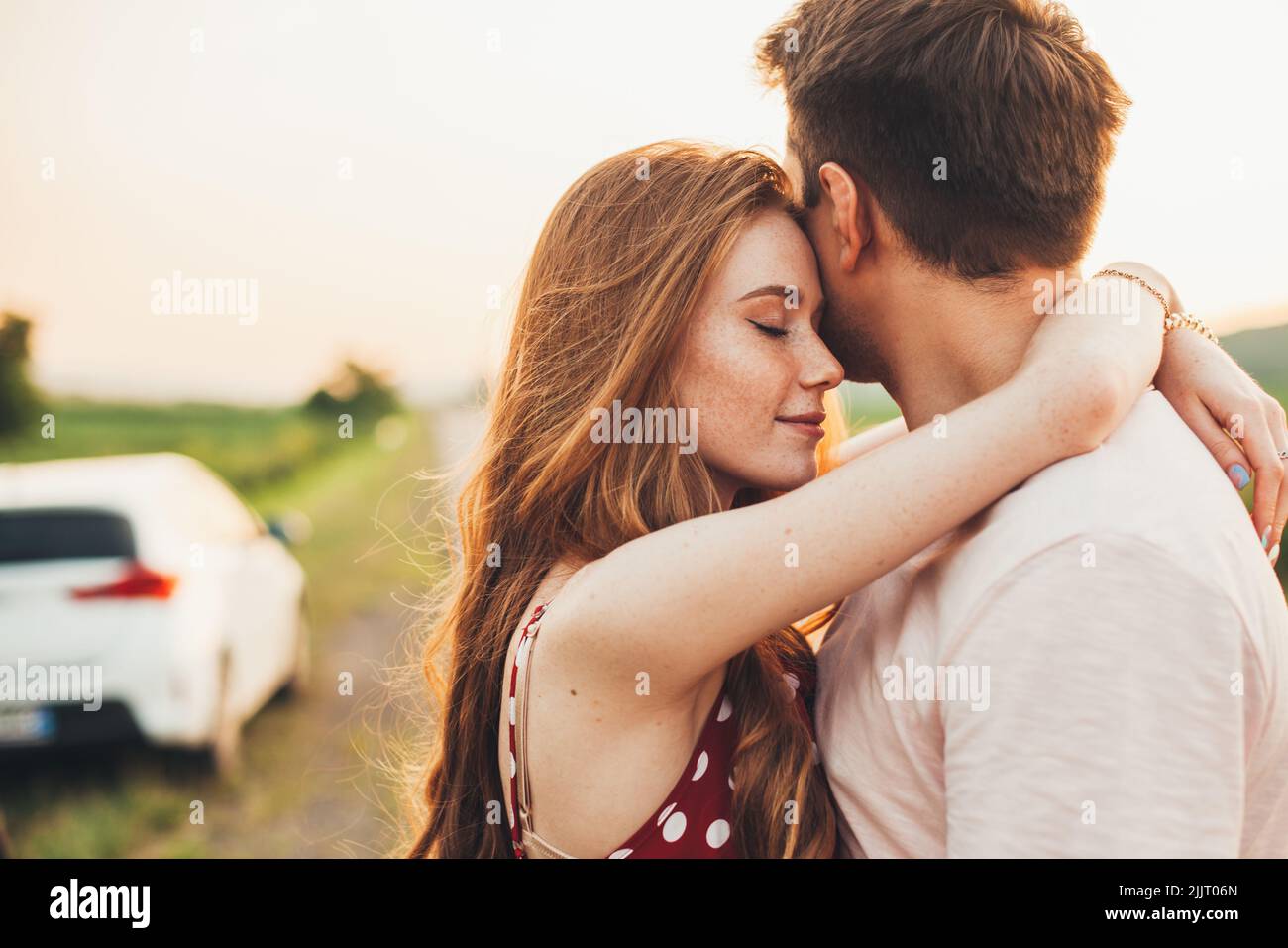 Man and woman hugging in holiday honeymoon trip on the road outdoors ...