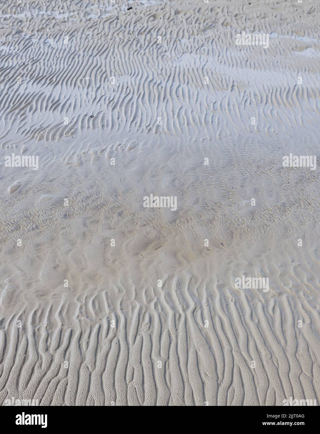 A vertical shot of lines and patterns on the sand on a beach Stock ...
