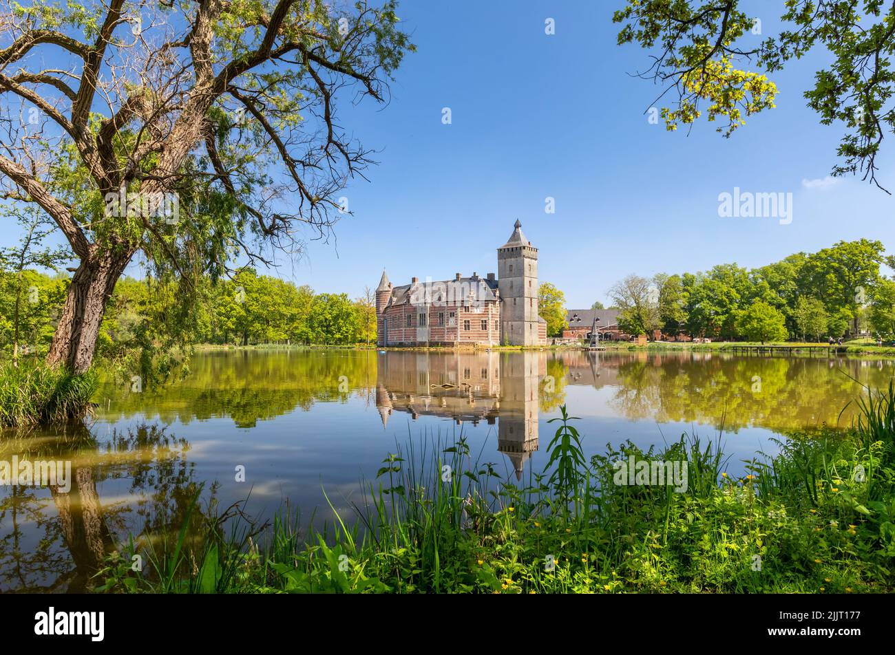 Holsbeek, Belgium - May 06 2022: View of historic Castle Van Horst with lake and park in summer day Stock Photo