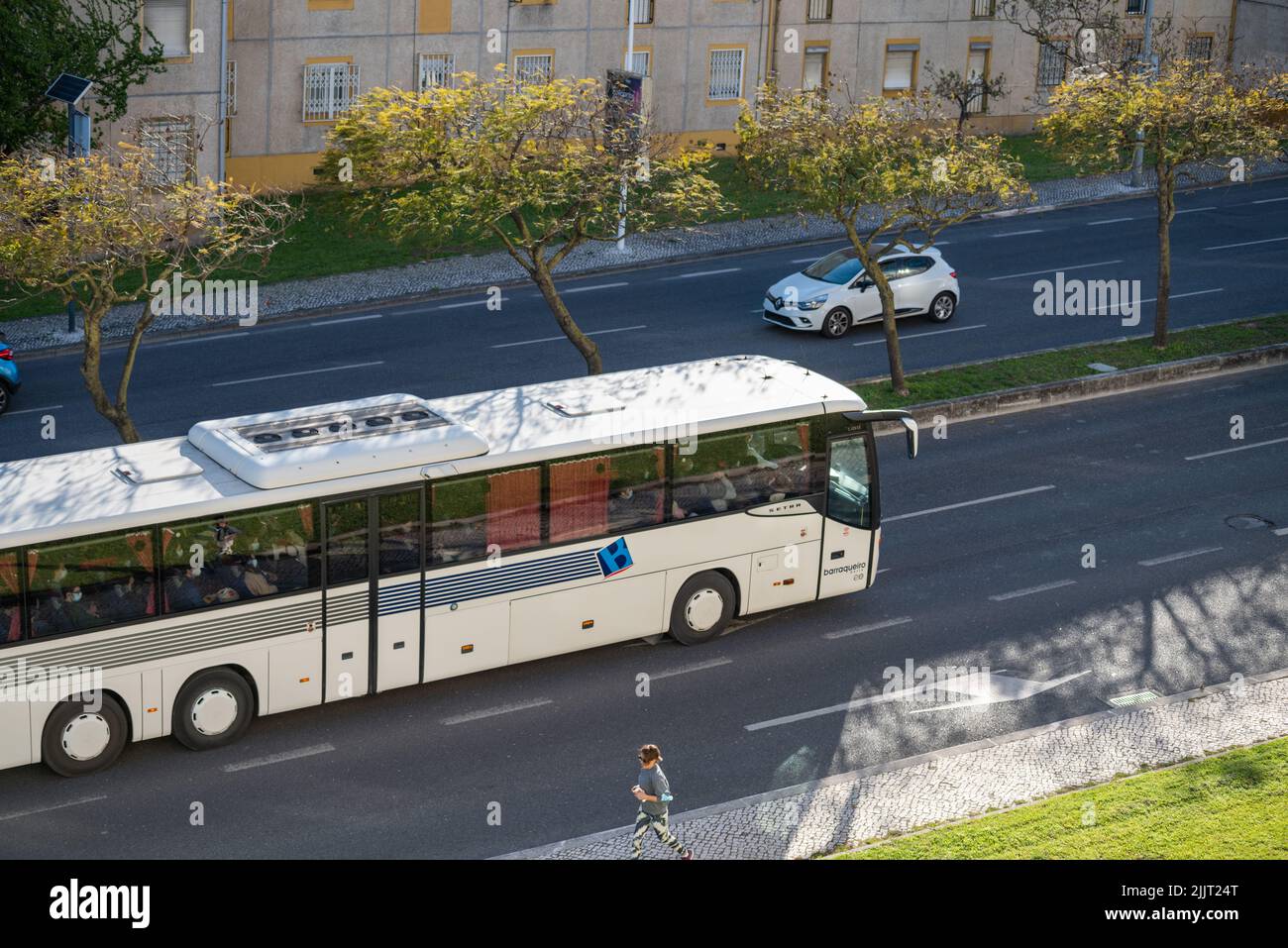 A scenic shot of a white passenger bus Barraqueiro in the streets of Lisbon, Portugal Stock Photo